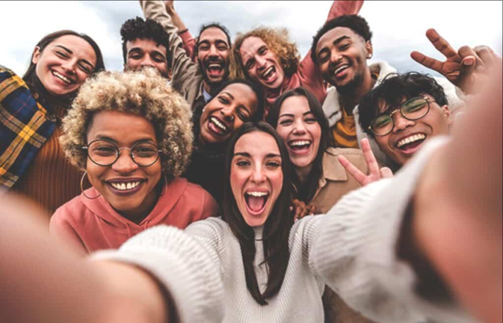 A group of friends enjoying services while taking a selfie.